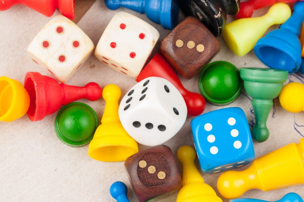 Colorful figures and dices of ludo family board game.